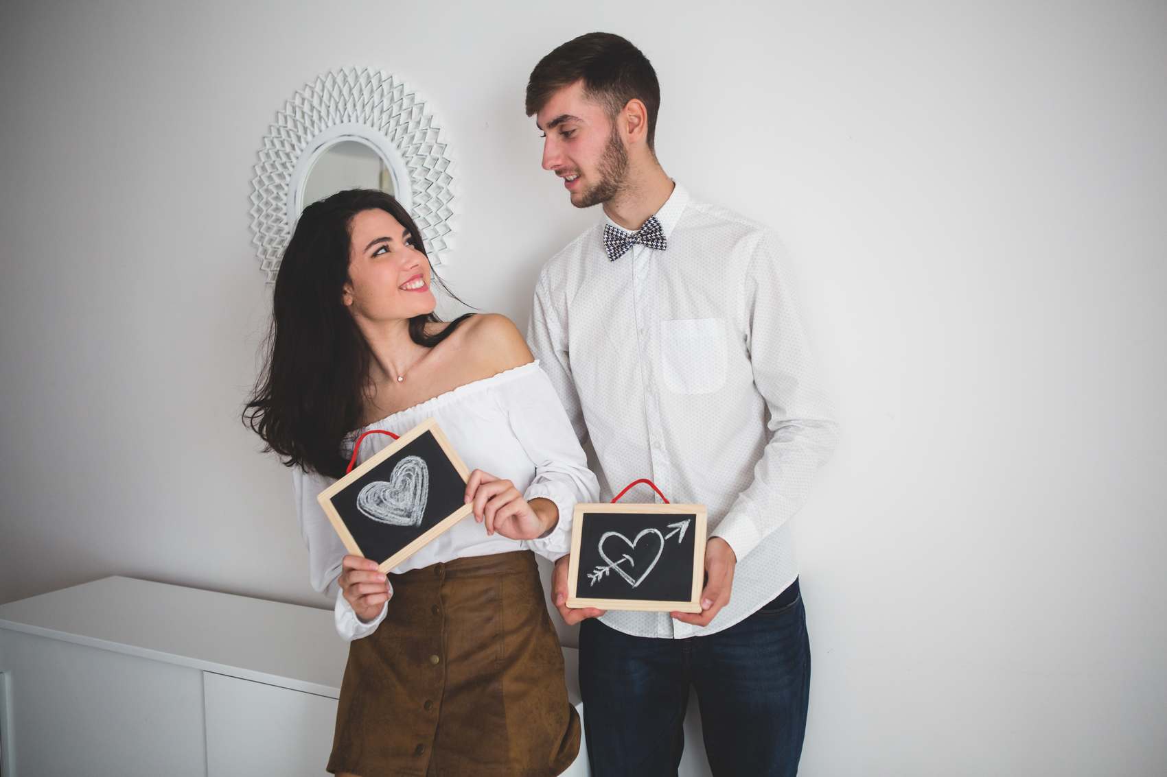 Couple Holding Black Slates with Drawn Hearts - I Saw You First Imaging, LLC